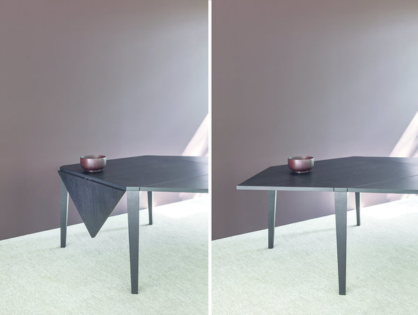 Table Quattrotto de forme carrée pour 4 personnes qui se transforme en table pour 8 personnes. Les allonges triangulaires cachées dans la structure de base permettent de doubler le nombre de convives en agrandissant d’un tiers la surface de la table. En contreplaqué de bois avec finition en chêne naturel, brun ou foncé. Création Angelo Mangiarotti, 1990, éditée par Agapecasa.