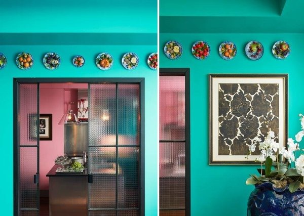 Au-dessus de la porte en verre armé qui sépare la salle à manger de la cuisine une collection d’assiettes en porcelaine avec trompe l’œil de fruits en relief réalisés par l’artiste Christine Viennet.