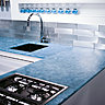 En cuisine, plan de travail en Magna GlasKeramik® (coloris Ocean Blue) qui ne craint ni les tâches d’huile, ni les acides ménagers.