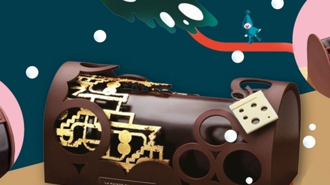 La Bûche Rêve d'Ailleurs est composée de biscuit aux amandes et à la noix de coco, dés d’ananas au chocolat pur Brésil, mousse au chocolat pur Brésil, biscuit cacao, crémeux au jus et zestes de citron vert, décor en chocolat noir ouvragé recouvert d’or fin.