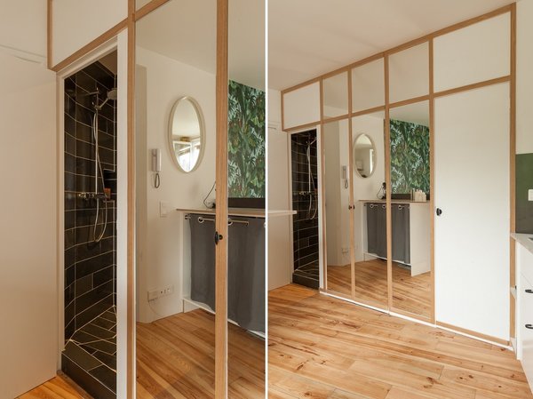 L’espace douche est dissimulé derrière un linéaire de portes avec une partie centrale consacrée au rangement.