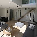 La double hauteur sous plafond profite au salon. Les marches de l’escalier sont insérées dans la maçonnerie en béton grâce à une réservation, avec ossature et poutre en métal, qui compose une structure porteuse.