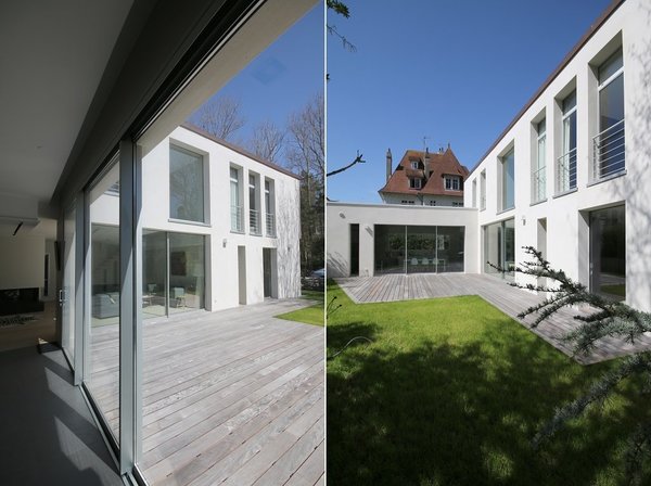 La façade sud minérale et vitrée offre un autre visage et une vue sur le jardin.