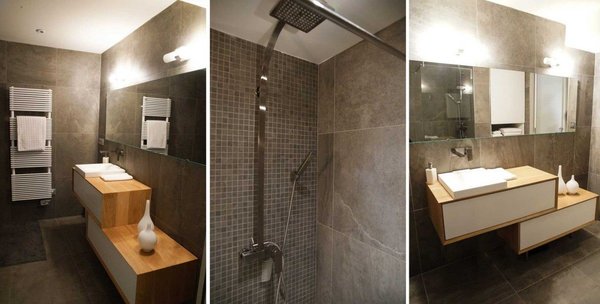 La salle de bains, nappée d’un carrelage minéral, est dotée d’un meuble dessiné par Carl Tran. Composé de deux blocs décalés, il offre une certaine légèreté visuelle qui change des modèles classiques et bénéficie d’une surface supplémentaire pour poser les affaires de toilette.