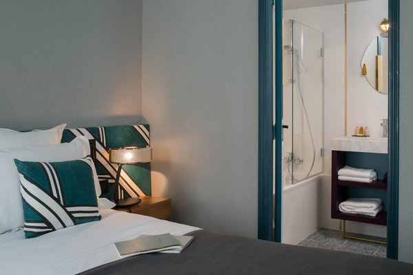 Dans les salles de bains, plinthes et sol en terrazzo. La couleur bleu paon relie la chambre à sa salle de bains.