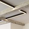 Un système d’éclairage a été incrusté dans le plafond. Les luminaires jouent avec la poutraison en béton.