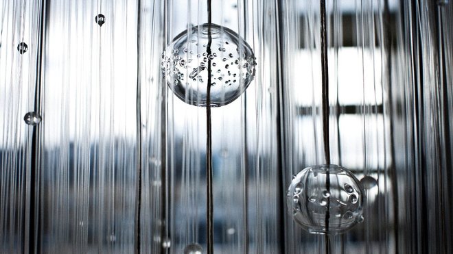 Inspiré par la nature, gouttes, boules, fibres, pluies de verre et de lumière détail sur le lustre Lluvia qui offre une vision spectaculaire de la transparence. Création Myriam Roland-Gosselin pour Verart.