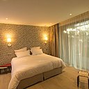 Tendance années 1950 et style vintage pour la décoration de cette chambre double. En tête de lit, papier-peint, modèle Little Trees, MissPrint.