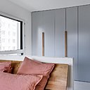 Suite parentale avec dressing placé derrière un muret de séparation qui cache le lit.