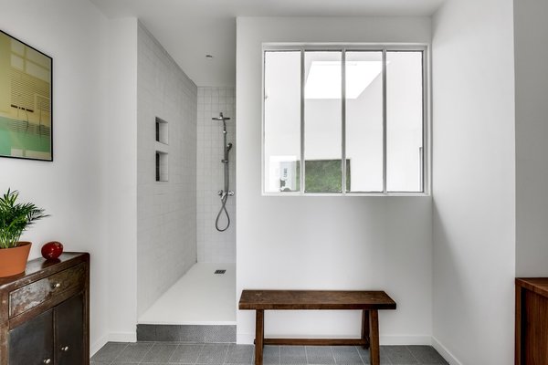 Seconde partie de la salle de bains des parents avec grande douche carrelée.