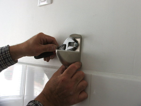 Etape 10 : placer les consoles inox, à droite comme à gauche des fixations de l’étagère à venir, afin de les fixer et serrer avec la clé à molette. Ne pas trop forcer sur le serrage de l’écrou au risque d’abîmer l’aspect inox de la console.